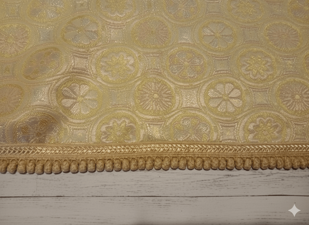 Decorative gold handmade pants with intricate patterns on a wooden surface