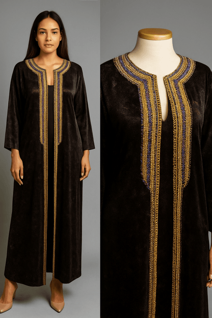 Black dress with gold embroidery on a gray background