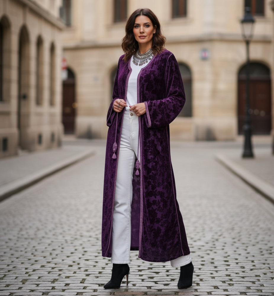 Woman wearing a long purple open kaftan velvet vintage in an urban setting