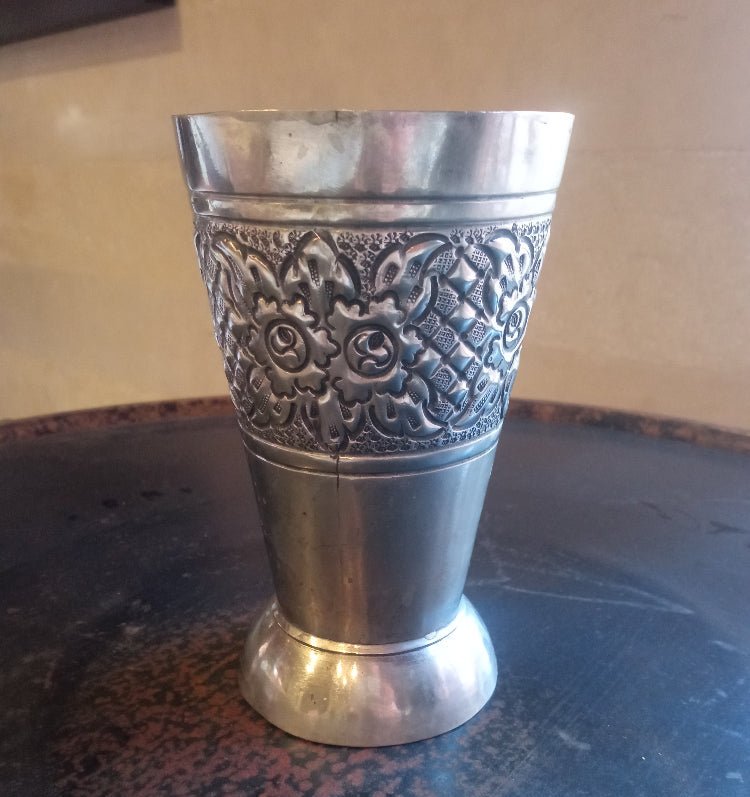 Silver decorative cup on a textured surface