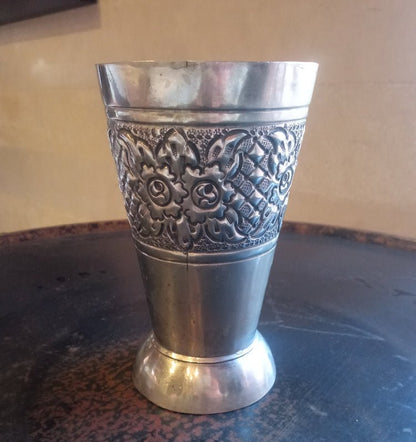 Silver decorative cup on a textured surface
