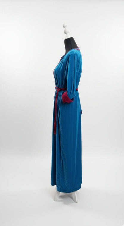 Blue dress with a red belt on a mannequin against a white background