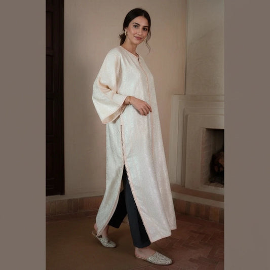 Woman wearing vintage ivory brocade Moroccan kaftan 