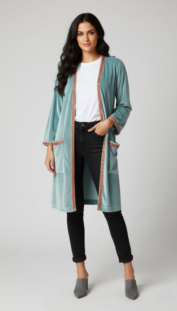 woman earing long beaded velvet jacket 