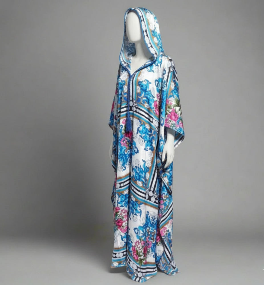 Colorful floral-patterned moroccan gandouradress on a mannequin against a gray background