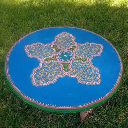 Decorative round coffe table moroccan mat with intricate patterns on grass