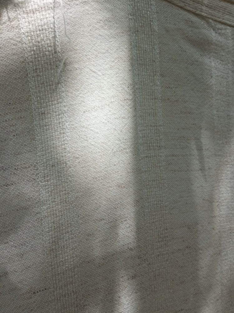 Close-up of a textured beige fabric surface
