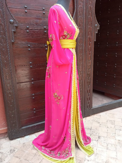 Pink saree with gold border draped over a wooden door