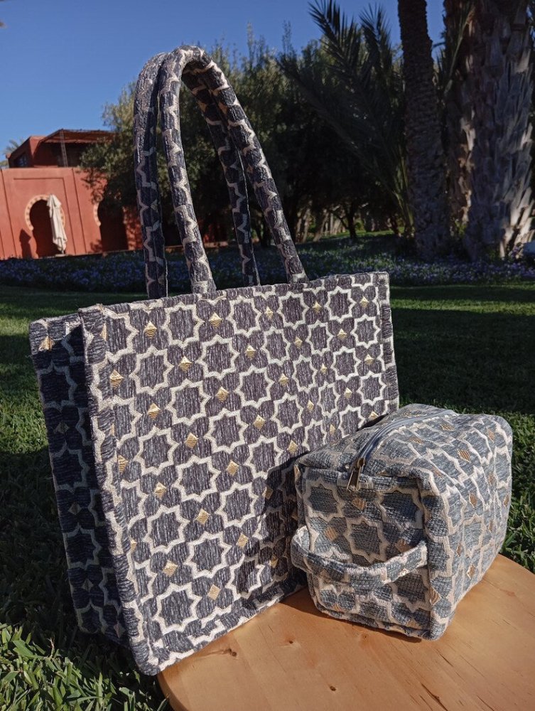 Patterned tote bag and small pouch on a wooden surface with a garden background