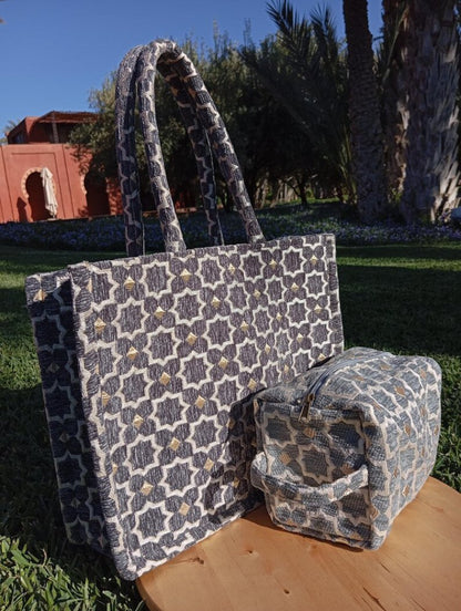 Patterned tote bag and small pouch on a wooden surface with a garden background
