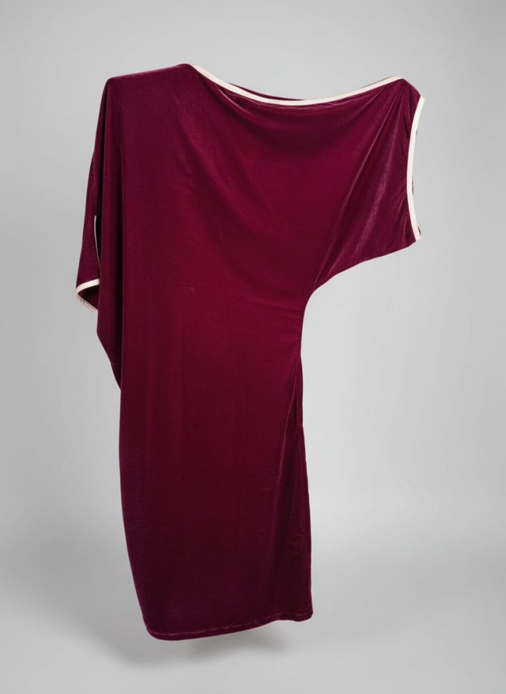 Red fabric draped over a structure with a natural background