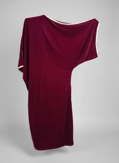 Red fabric draped over a structure with a natural background