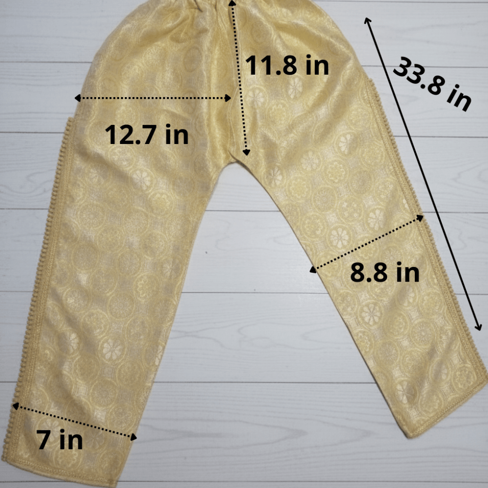 Beige pants with measurements on a white wooden surface