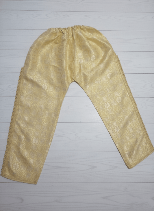 Beige embroidered pants on a light wooden floor